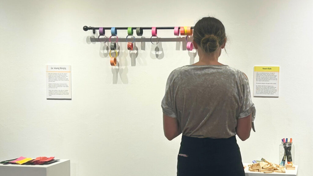 someone is looking at art in a gallery